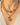 An antique citrine necklace and a gold chain with pendant charms being worn one on top of another